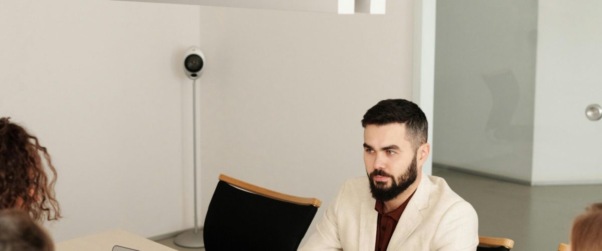 A diverse group engaged in a business meeting in a modern office setting.